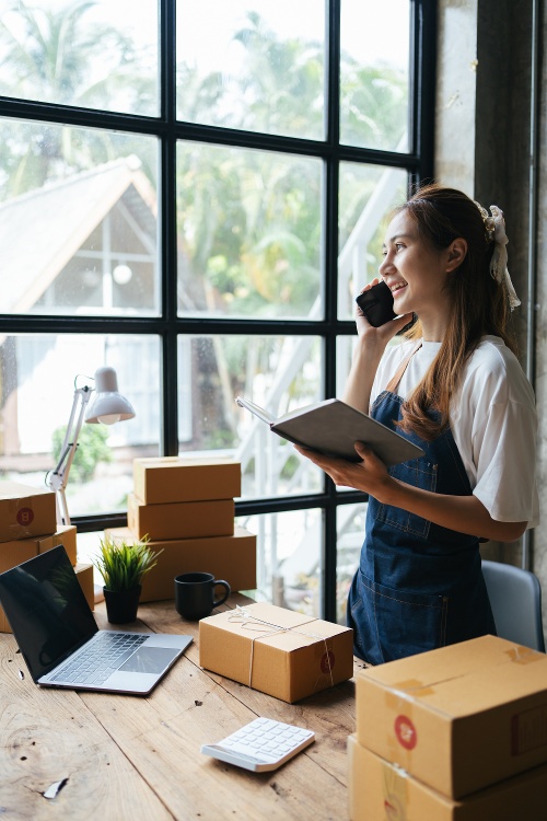 Marketer talking on the phone and planning her day.