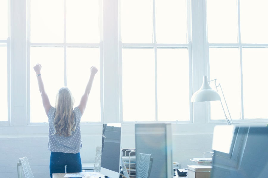 Image of Successful Marketer Raising Her Hands in Victory